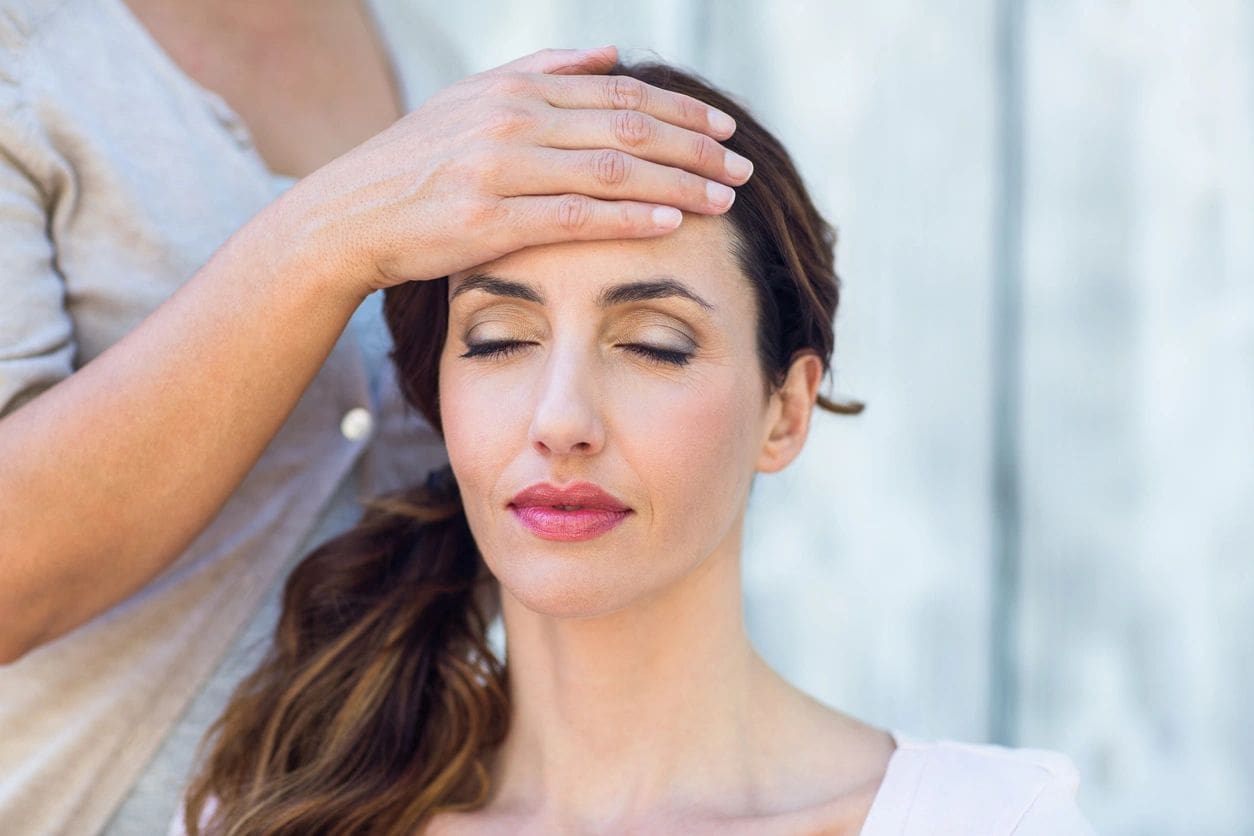 A woman with her hands over her head