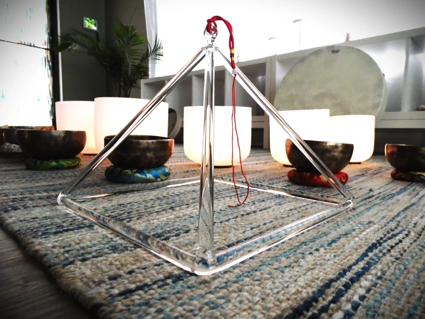 A glass pyramid sitting on top of a rug.